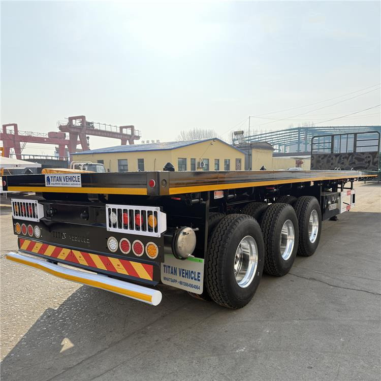 TITAN 12.5M 3 Axle Flat Deck Trailer for Sale In Tanzania - Semirremolque portacontenedore/ Intercambiable: foto 1 TITAN 12.5M 3 Axle Flat Deck Trailer for Sale In Tanzania - Semirremolque portacontenedore/ Intercambiable: foto 1
